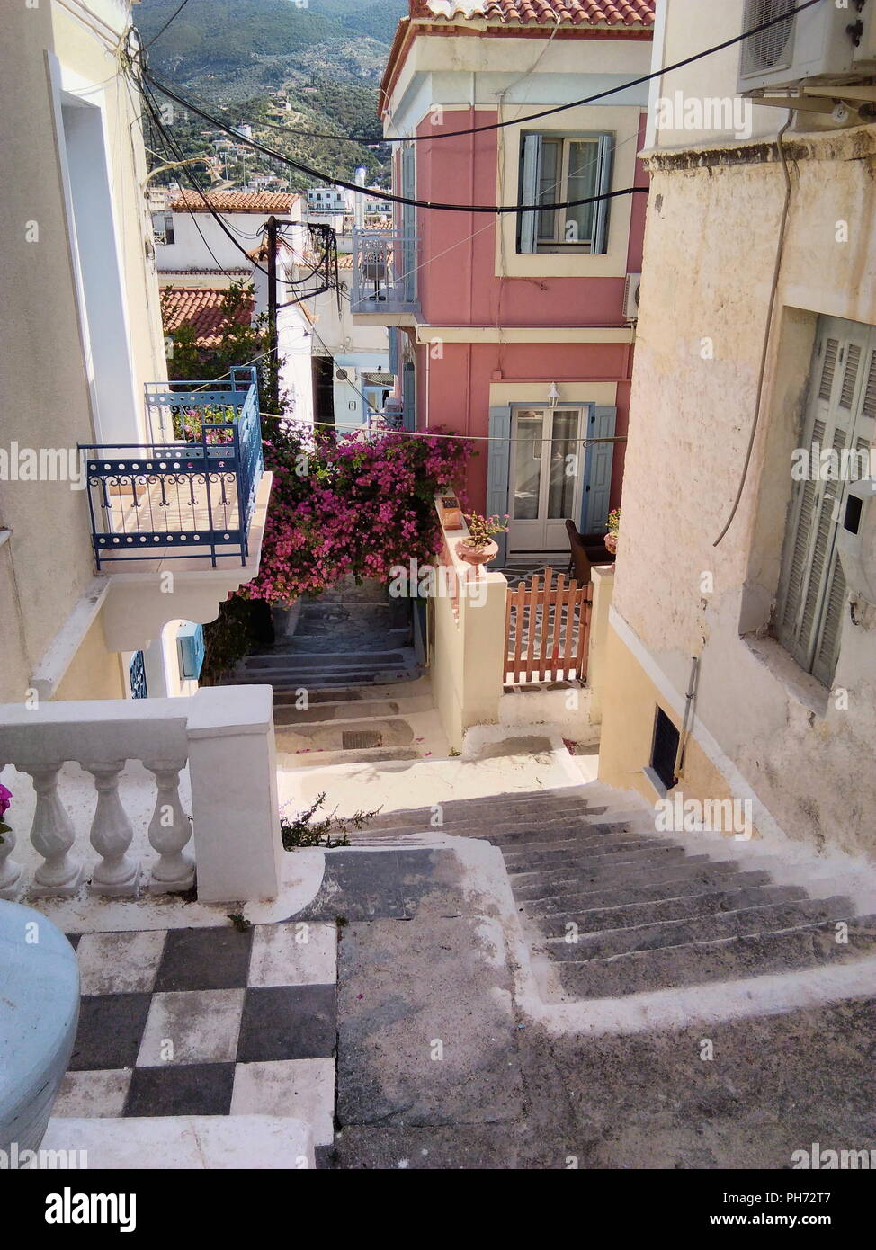 Greece, the small and pretty island of Poros.  The old town, a view down a flight of steps towards the harbor. Stock Photo