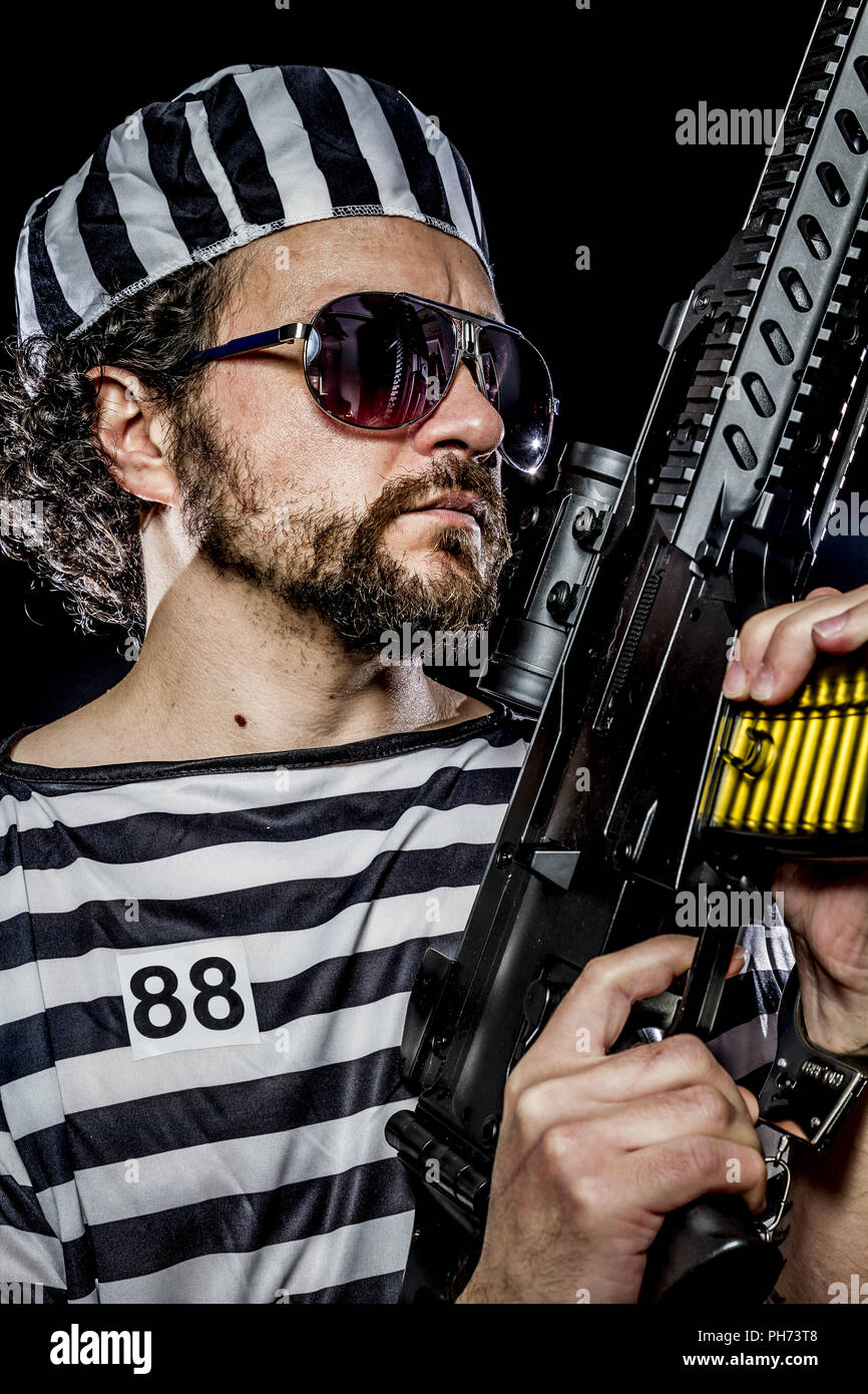 Security.Prison riot concept. Man holding a machine gun, prisoner Stock Photo