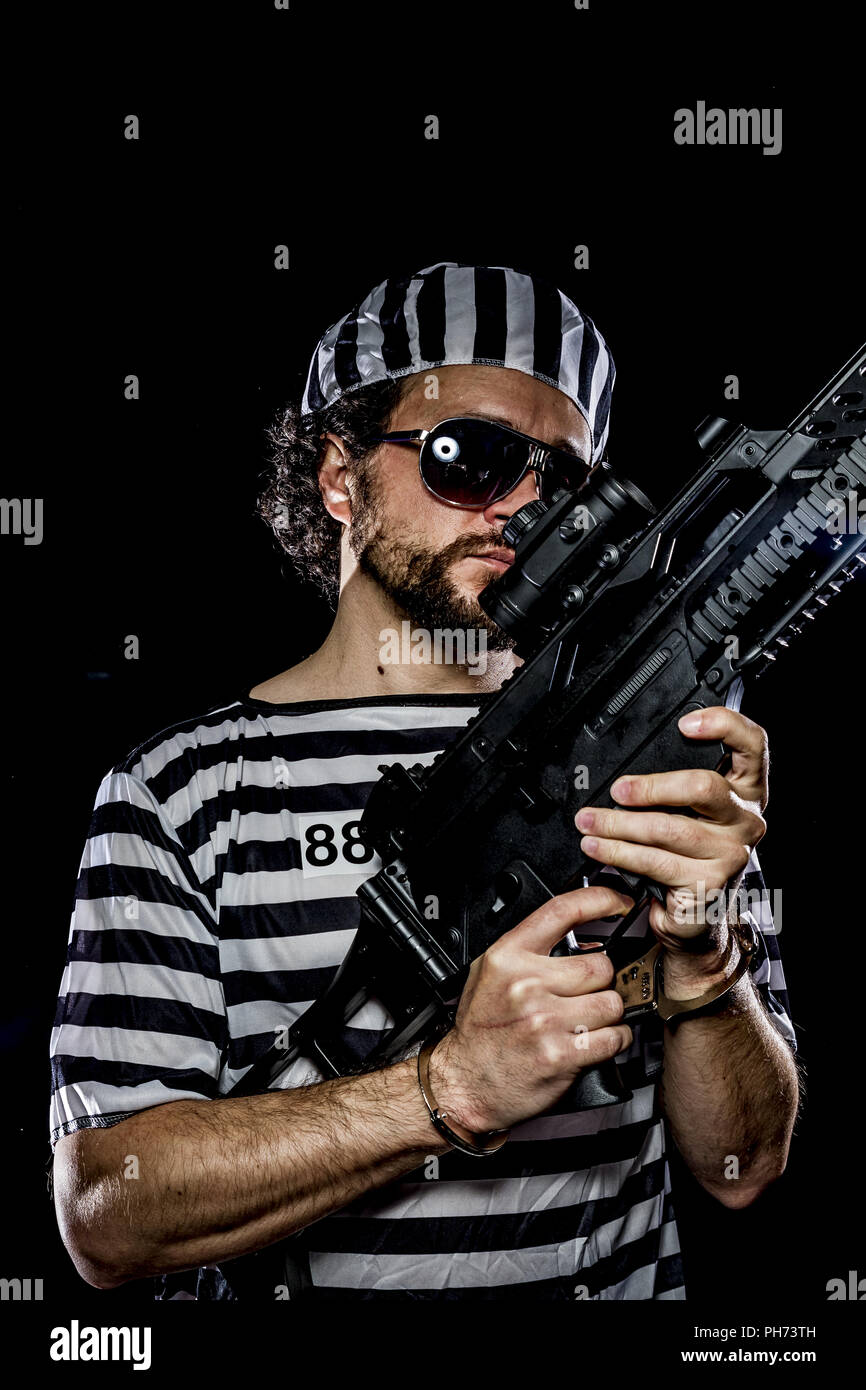 Freedom .Prison riot concept. Man holding a machine gun, prisoner Stock Photo