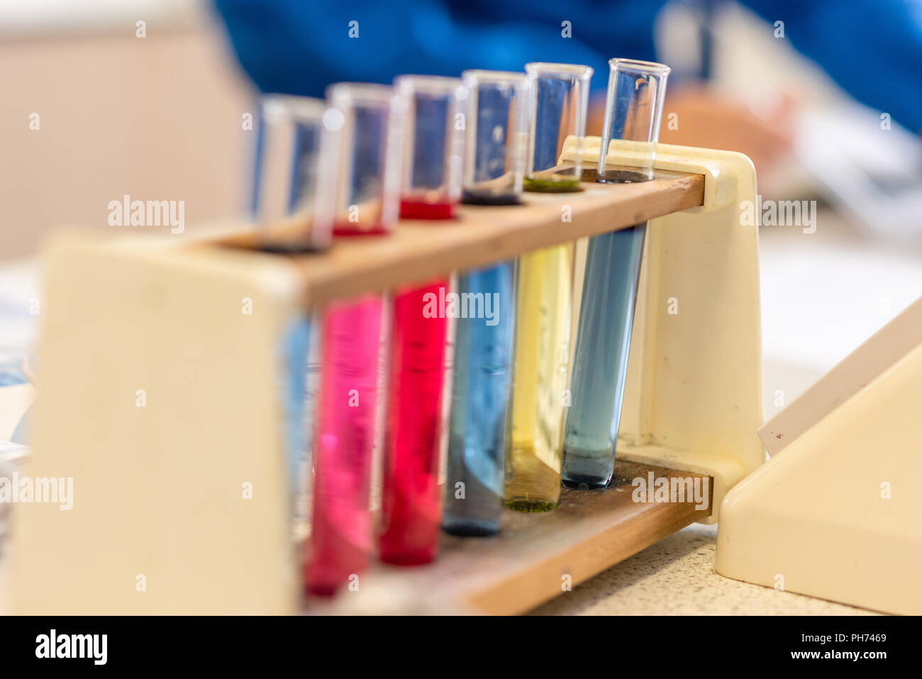 Coloured test tubes photographed in a school classroom during a science