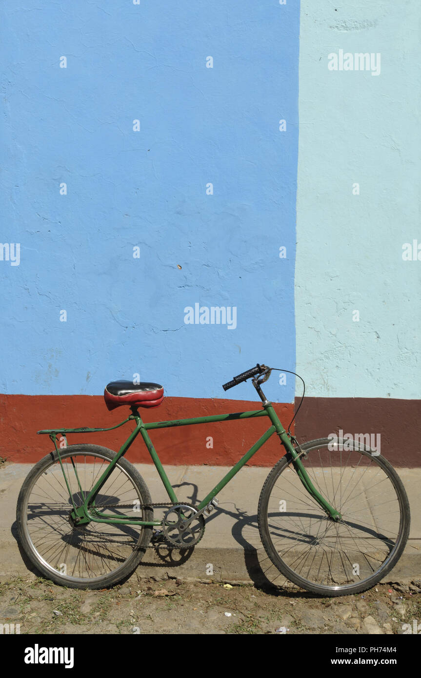 Old green bicycle roadside with copy space. Stock Photo