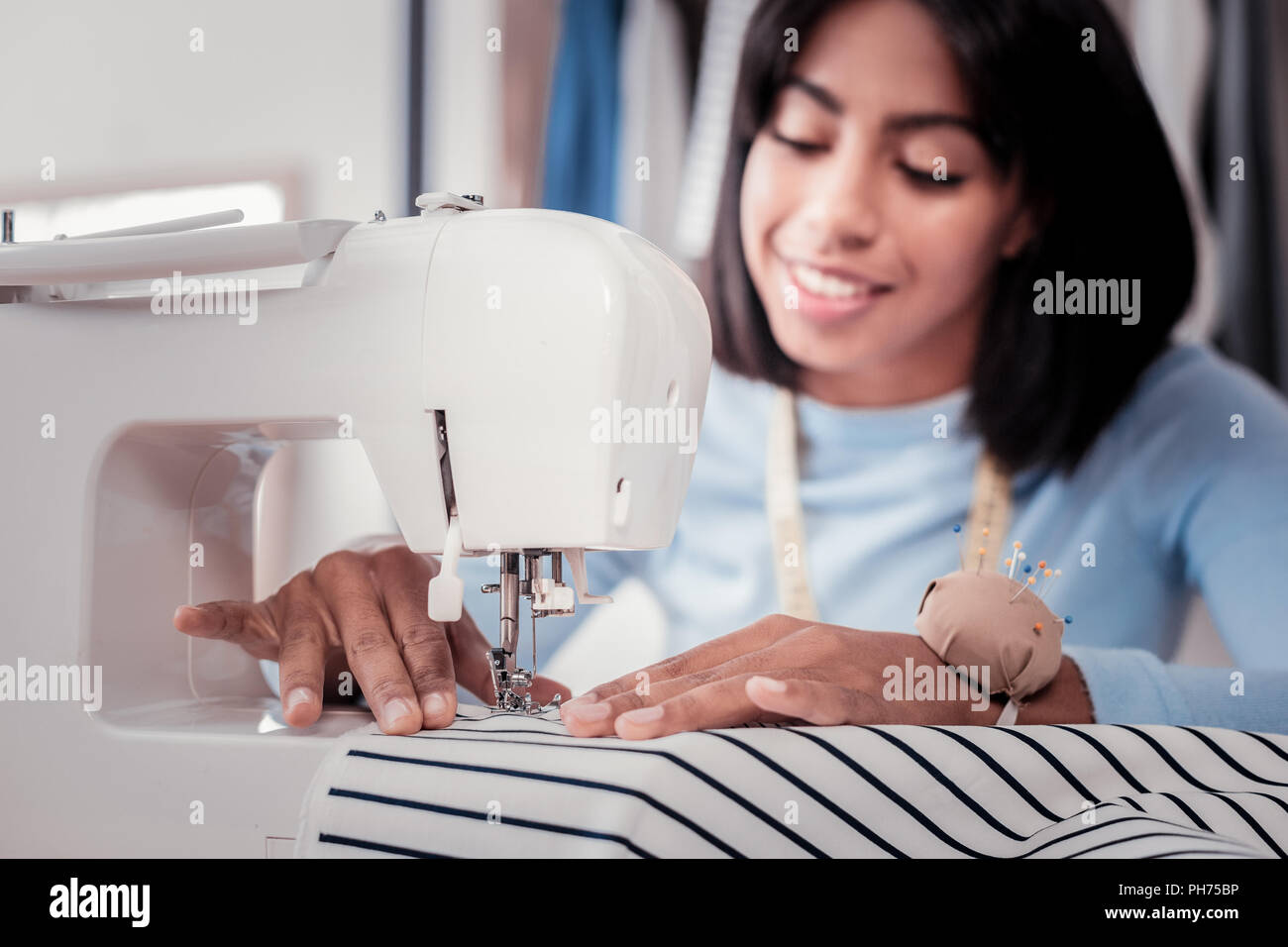 Close up of sewing machine being used by skilled tailor Stock Photo