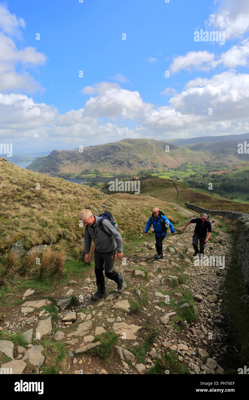 Walkers on Patterdale Common and Ullswater lake, Lake District National Park, Cumbria, England, UK Stock Photo