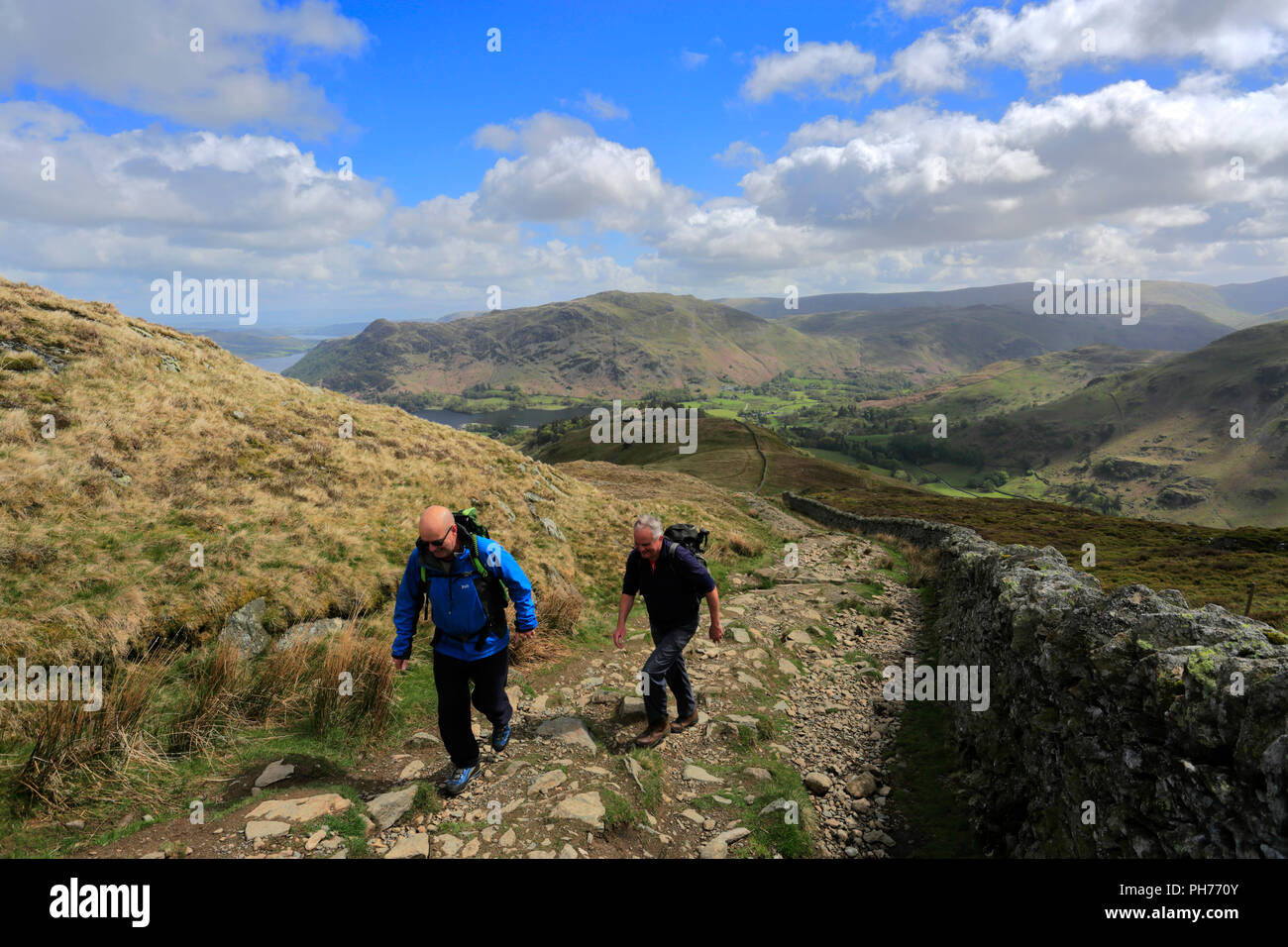 Walkers on Patterdale Common and Ullswater lake, Lake District National Park, Cumbria, England, UK Stock Photo