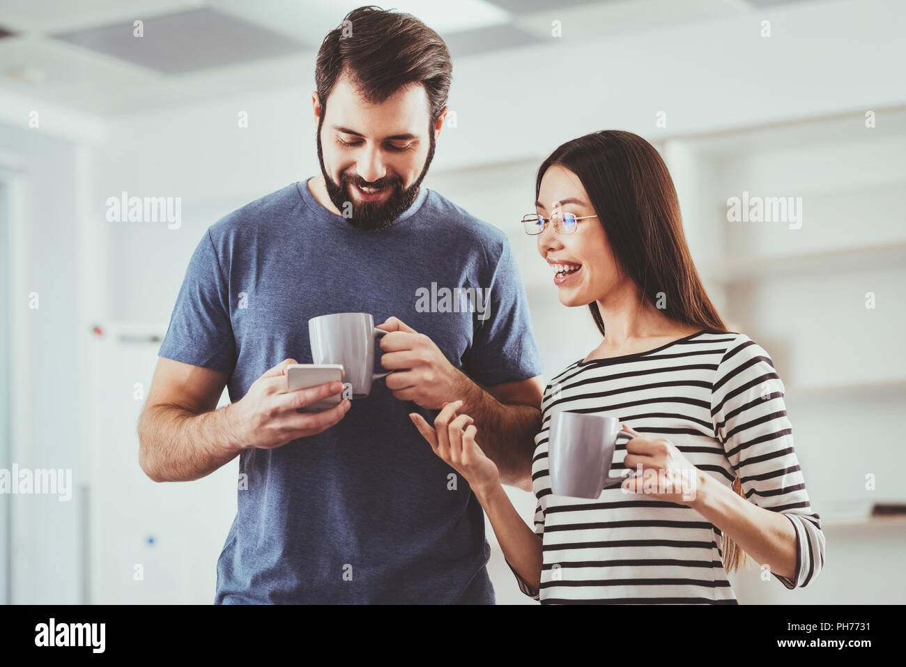 Nice pleasant man using his smartphone Stock Photo