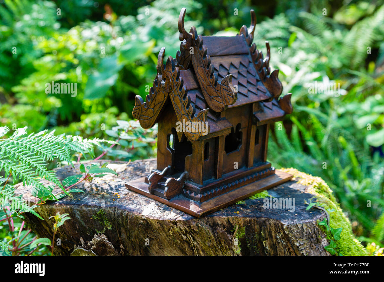 Thai Spirit House in Garden Stock Photo