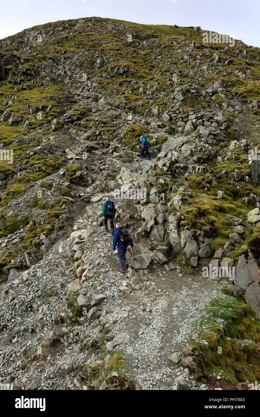 Walkers on Striding Edge ridge on the way to Helvellyn fell, Lake ...