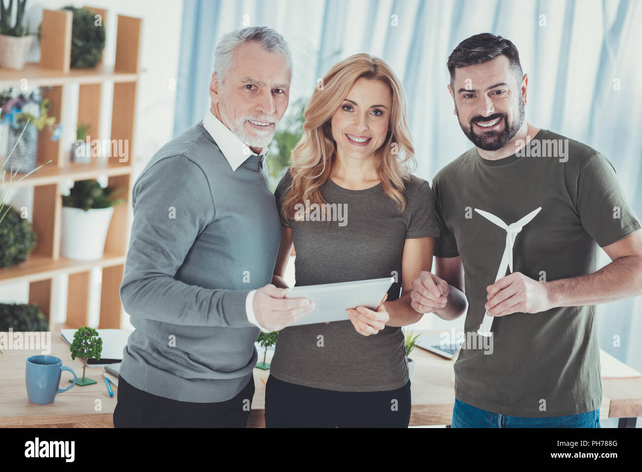 Positive three colleagues enumerating pluses Stock Photo