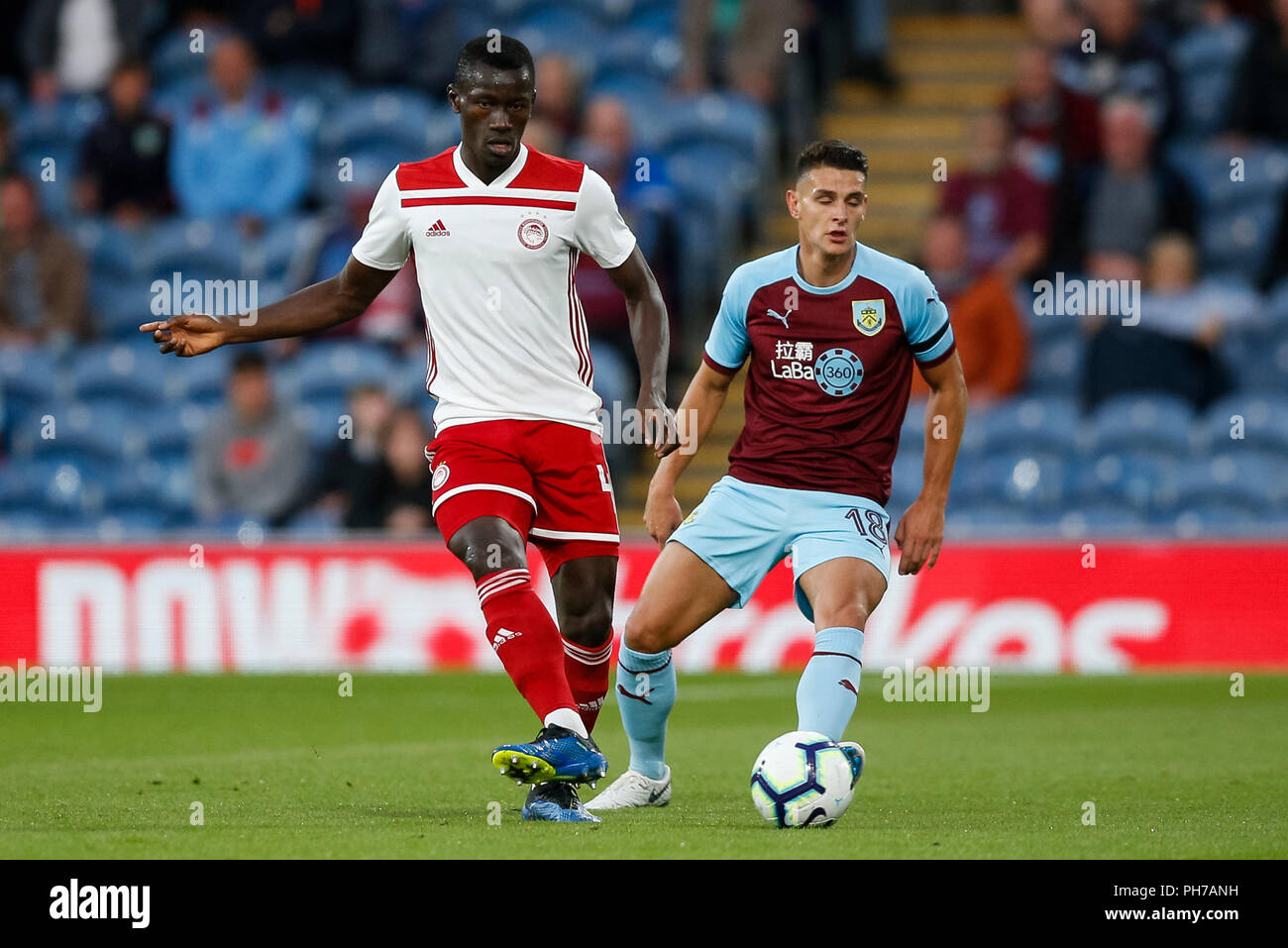 Burnley, UK. 30th August 2018. Mady Camara of Olympiakos and Ashley  Westwood of Burnley during the UEFA Europa League Play-Off Round second leg  match between Burnley and Olympiakos at Turf Moor on