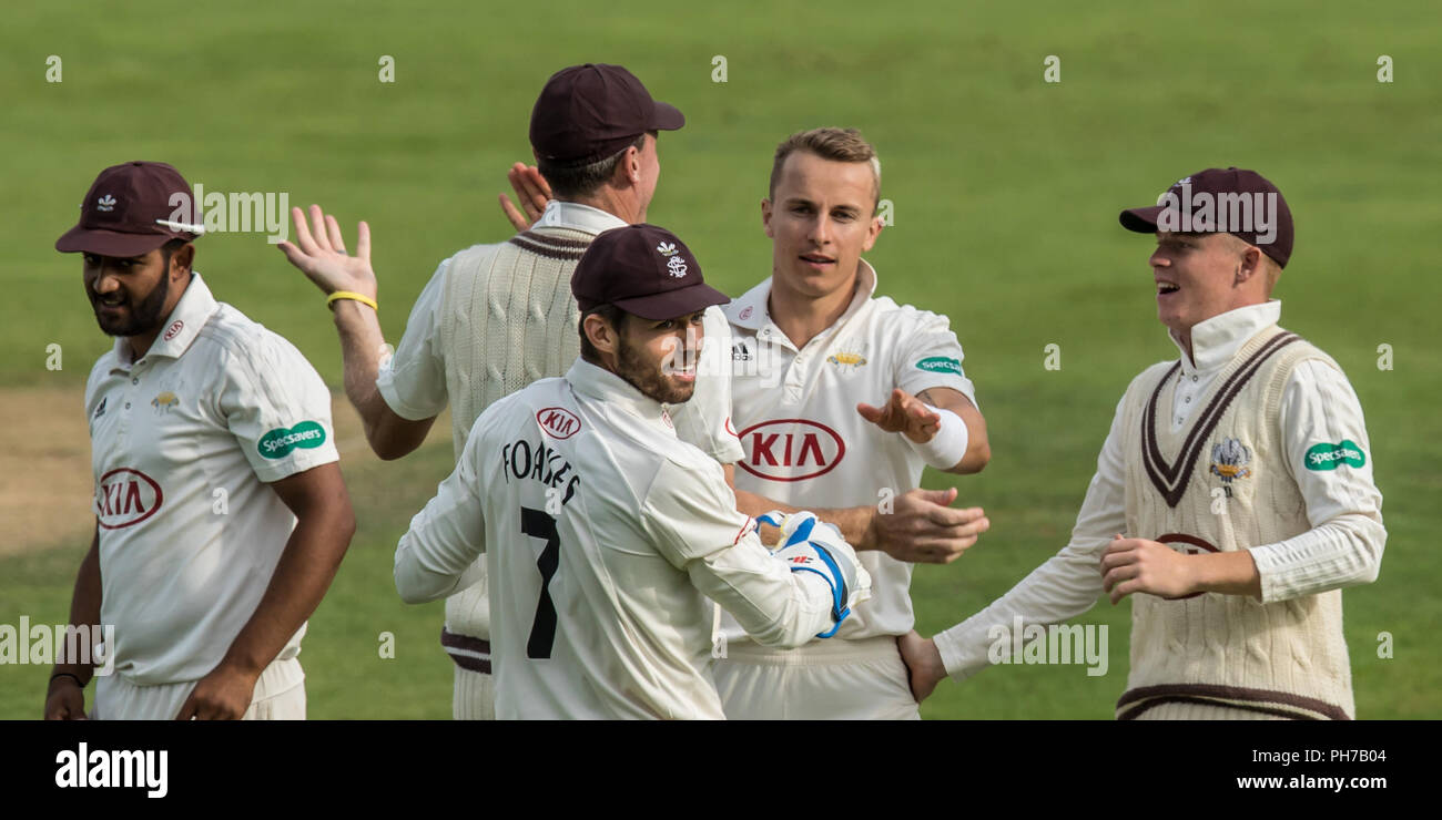 London, UK. 30 August 2018. Tom Curran celebtrates with team mates after getting the wicket of Luke Fletcher bowling for Surrey against Nottinghamshire on day two of the Specsavers County Championship game at the Kia Oval. David Rowe/Alamy Live News Stock Photo