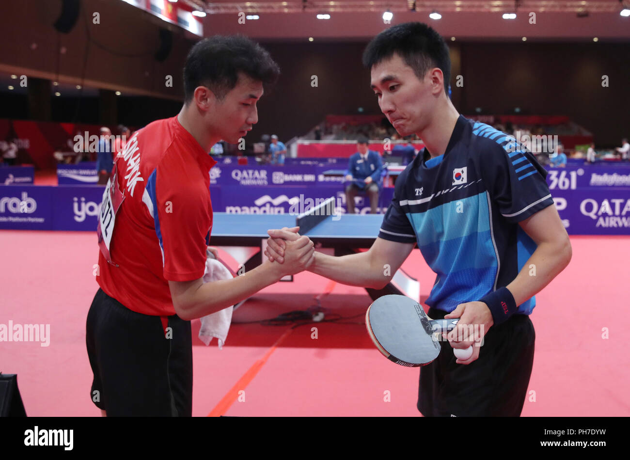 Seoul, South Korea. 31st Aug, 2018. Two Koreas compete in Asiad table tennis  South Korea's Lee Sang-su (R) and North Korea's Pak Sin-hyok shake hands  after ending their round of 16 singles