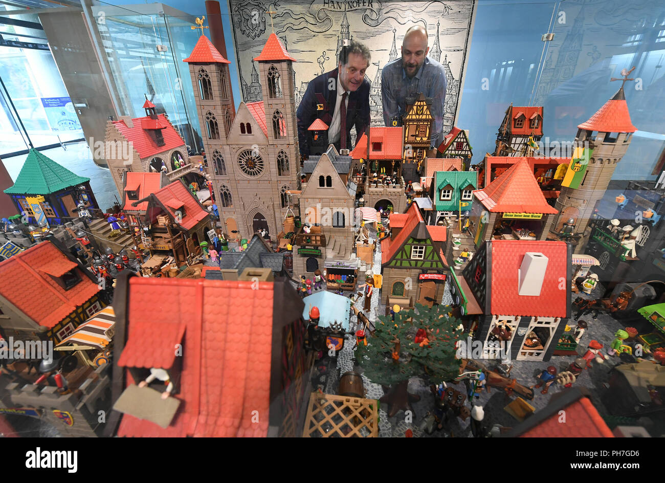 Hanover, Germany. 31st Aug, 2018. Thomas Schwark (l), Director of the  Historisches Museum Hannover, and hobby craftsman and exhibition designer  Robert Packeiser (r), look at a diorama of a medieval world in