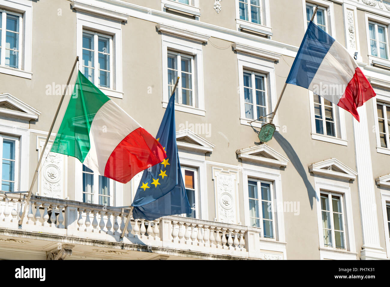the concept of the recent political conflict between the President of the French Republic Emmanuel Macron and the Italian Vice Premier Matteo Salvini on the problems of immigration and the refugees. Image taken on the facade of the building housing the French consulate in Trieste, Italy Stock Photo