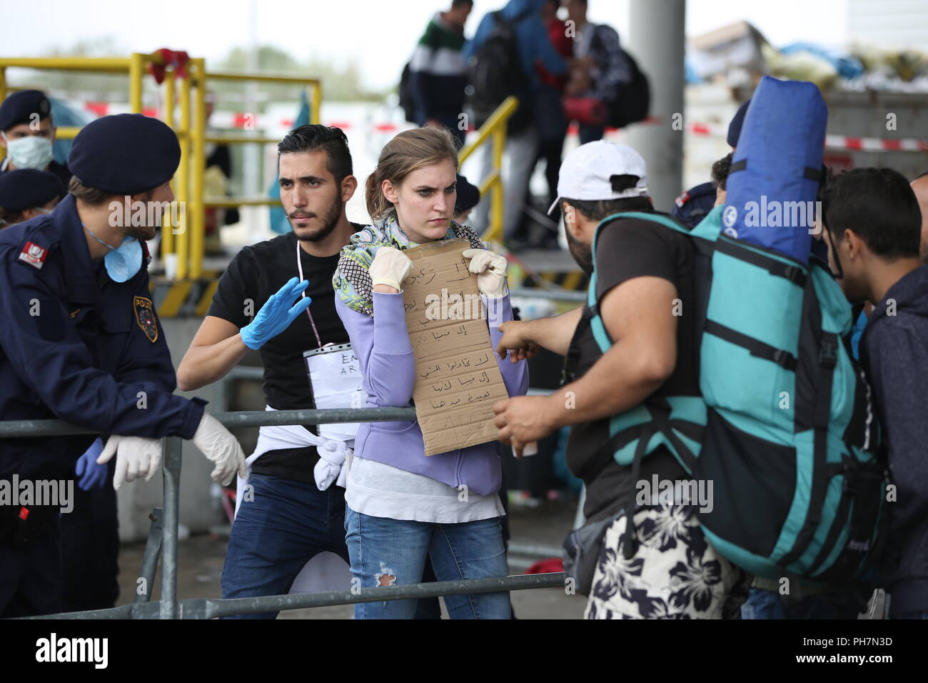 Nickelsdorf, Burgenland, Austria. 15th Sep, 2015. Aid workers seen helping refugees.The Austrian military took control of managing arriving Refugees at the Austrian/Slovenian border Crossing Spielfeld. They were supported by the Christian NGO Caritas. The refugees were mostly from Syria, Afghanistan and Iraq. Credit: Stanislav Jenis/SOPA Images/ZUMA Wire/Alamy Live News Stock Photo