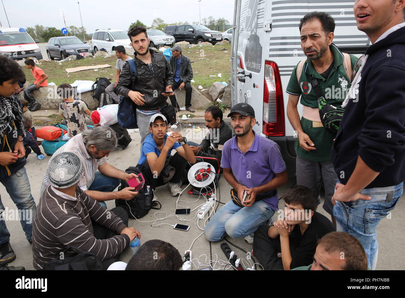 Nickelsdorf, Burgenland, Austria. 15th Sep, 2015. Refugees seen resting on the ground.The Austrian military took control of managing arriving Refugees at the Austrian/Slovenian border Crossing Spielfeld. They were supported by the Christian NGO Caritas. The refugees were mostly from Syria, Afghanistan and Iraq. Credit: Stanislav Jenis/SOPA Images/ZUMA Wire/Alamy Live News Stock Photo
