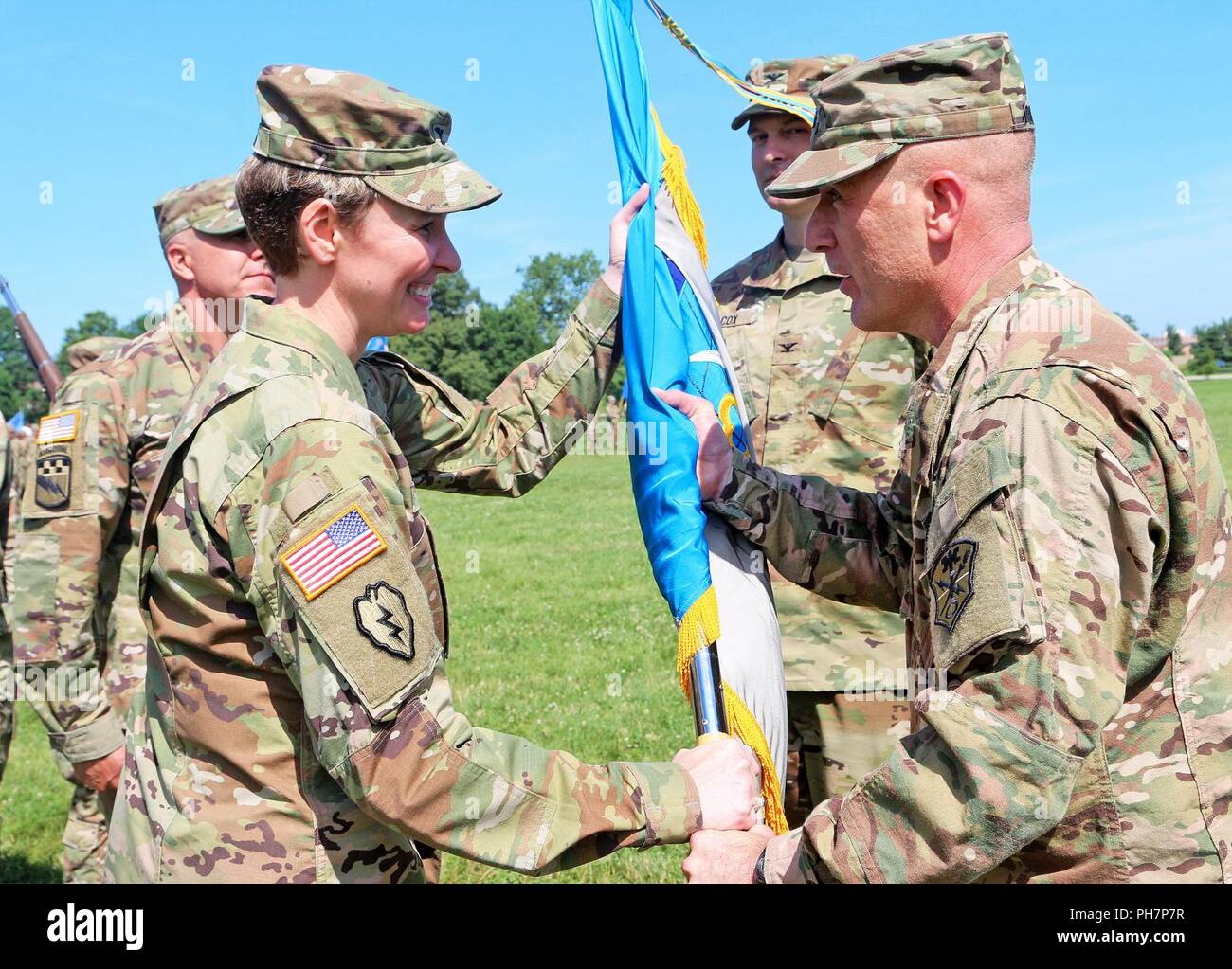 (Right) Maj. Gen. Gary W. Johnston, commanding general, U.S. Army Intelligence and Security Command passes the brigade colors to Col. Heidi A. Urben the new 704th Military Intelligence Brigade commander, during a change of command ceremony, at Fort Meade’s parade field, Fort Meade, Maryland, June 26, 2018. Urben assumed command of the 704th Military Intelligence Brigade, from the outgoing commander, Col. Rhett R. Cox. ( Stock Photo