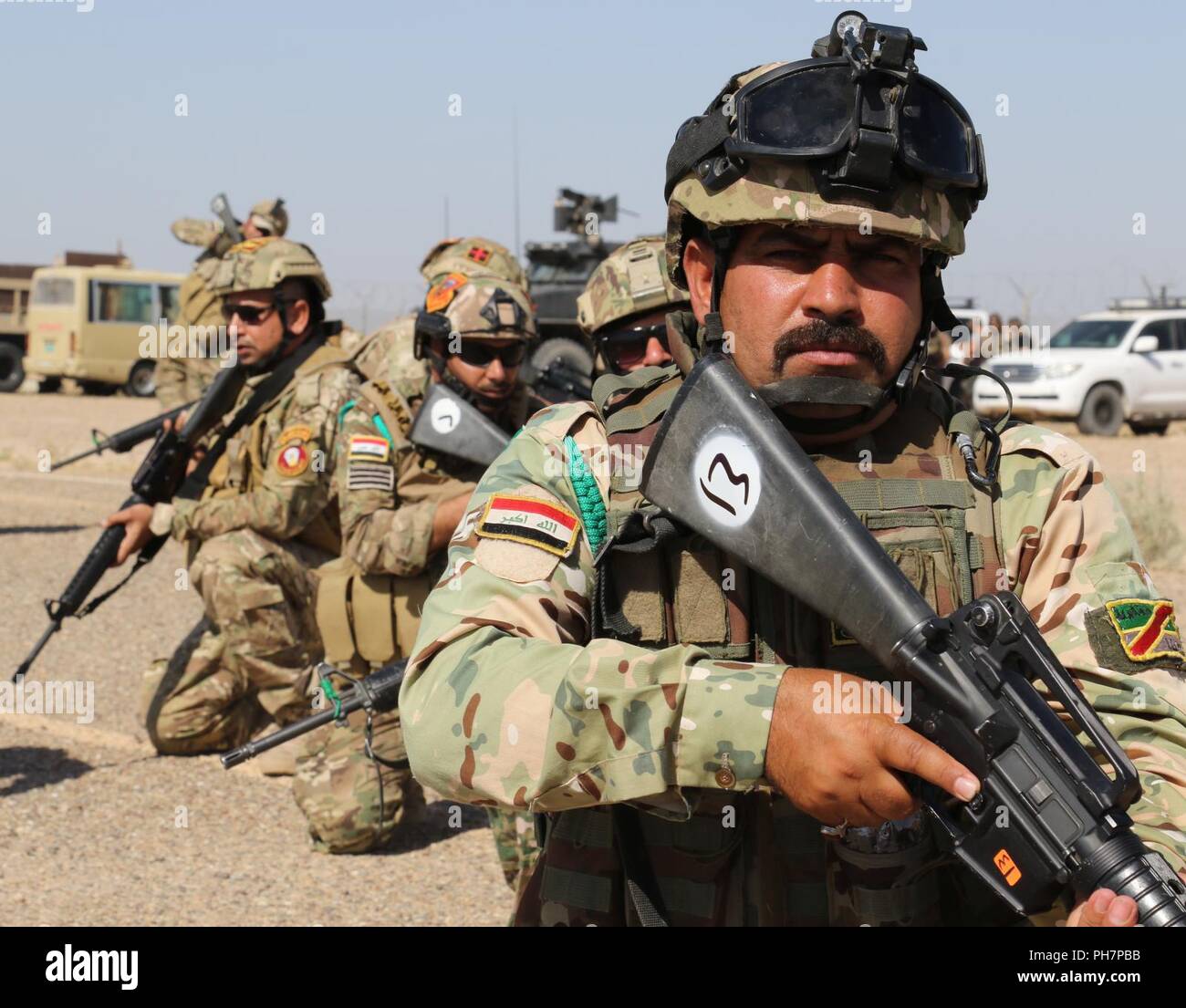 Anbar Operations Center Commandos take a knee during training at Al