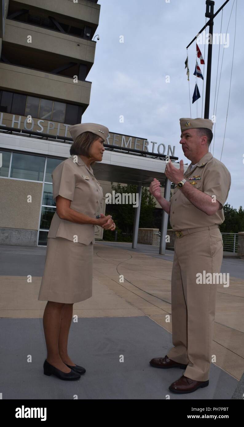 Command quarterdeck vantage points and viewpoints... Navy Vice Adm. Raquel C. Bono, director of the Defense Health Agency, exchanges assessments and insight with Capt. Jeffrey Bitterman, Naval Hospital Bremerton commanding officer, as part of a fact-finding visit to the command to see - and hear - first hand on issues and improvements since the deployment of the new electronic health record MHS GENESIS on Sept. 23, 2017. NHB was one of the four sites in the Pacific Northwest, along with U.S. Air Force 92nd Medical Group at Fairchild Air Force Base, Naval Health Clinic Oak Harbor and Madigan Ar Stock Photo