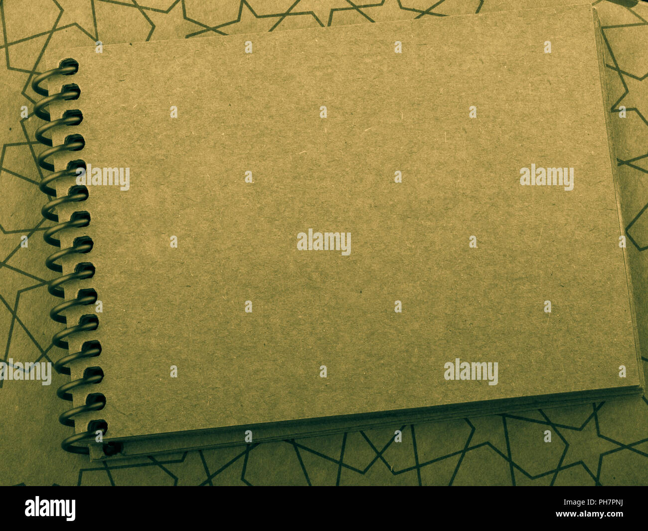 Spiral notebook placed on a straw background Stock Photo - Alamy