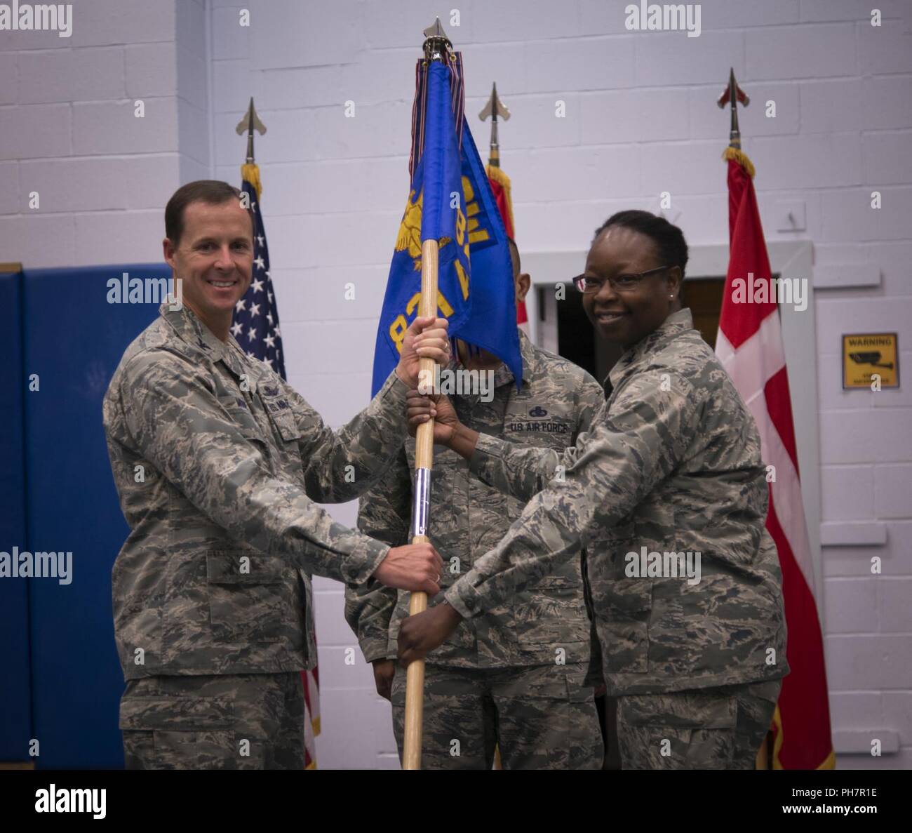 THULE AIR BASE, Greenland – Col. Todd Moore, 21st Space Wing commander, passes the guidon to Col. Mafwa Kuvibidila, 821st Air Base Group commander, during the 821st Air Base Group change of command ceremony, June 28, 2018, at Thule Air Base, Greenland. Kuvibidila was the commander of the 20th Space Control Squadron, Eglin Air Force Base, Florida from June 2014 to June 2016. Stock Photo