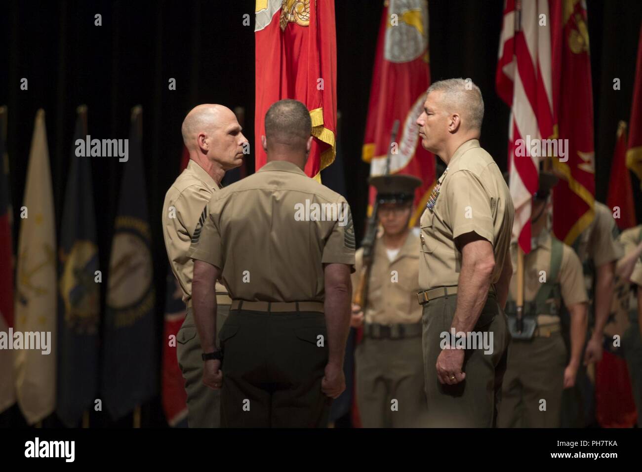 U.S. Marine Corps Maj. Gen. Robert S. Iiams, left, out-going commanding general, Training and Education Command (TECOM), holds the unit’s colors during the TECOM change of command ceremony at Warner Hall on Marine Corps Base Quantico, Va., June 29, 2018. The ceremony was held to relinquish the command from Iiams to Maj. Gen. William F. Mullen III. Stock Photo