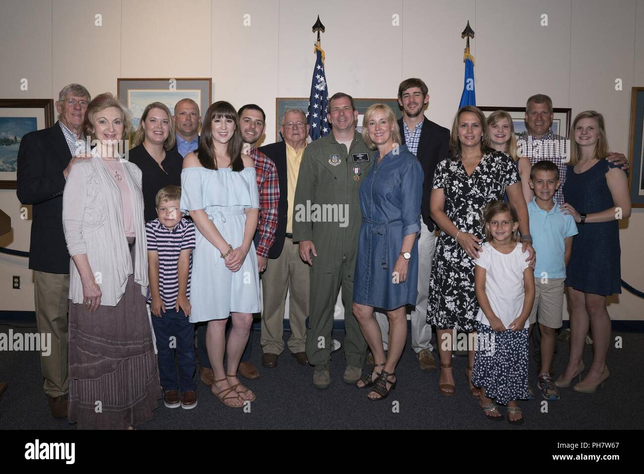 Retired Col. Jeffrey Brett and his family take a group photo during a retirement ceremony at the Museum of Aviation, Robins Air Force Base, Ga., June 22, 2018. Brett is a former commander of the 413th Flight Test Group who served in the position from March 2015 to June 2016. His most recent assignment was at Stuttgart, Germany, as a battle watch captain for the U.S. European Command. Stock Photo