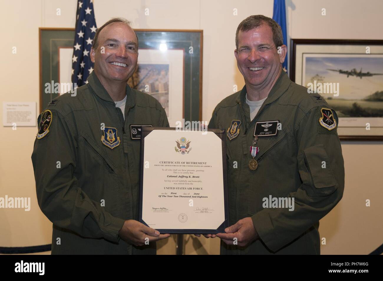 Col. Jeffrey Brett, right, receives a certificate of retirement from retired Col. Jerry Byars during a retirement ceremony at the Museum of Aviation, Robins Air Force Base, Ga., June 22, 2018. Brett is a former commander of the 413th Flight Test Group who served in the position from March 2015 to June 2016. His most recent assignment was at Stuttgart, Germany, as a battle watch captain for the U.S. European Command. Stock Photo