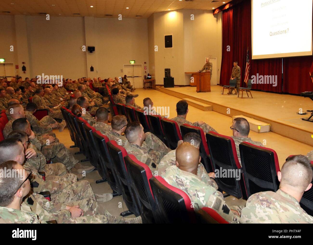 CAMP ARIFJAN, Kuwait — Soldiers with Headquarters and Headquarters Battalion, 28th Infantry Division/Task Force Spartan, attend a town hall meeting June 29, 2018. Maj. Gen. Andrew Schafer, division commander, started the event with a brief overview of the division’s storied history. Stock Photo