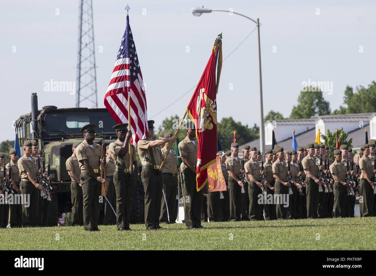 U.S. Marines present colors at The Basic School (TBS) during a change of command ceremony between Col. Mark Clingan and Col. David Everly at TBS, Quantico, Va., June. 15, 2018. The mission of TBS is to train and educate newly commissioned or appointed officers. Stock Photo