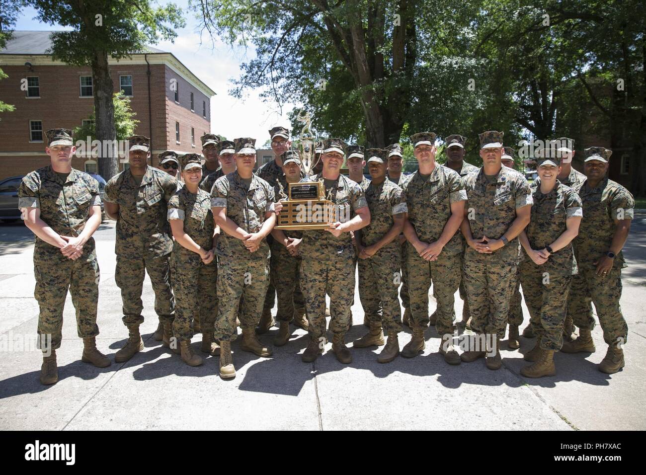 U.S. Marines with G-4: Logistics pose for a group photo after being awarded the Commander's Cup for intramural sports at Yale Hall, Marine Corps Base Quantico, Va., June 14, 2018. The Intramural Sports Commander’s Cup depicts the Marines’ esprit de corps and the embodiment of teamwork and outstanding leadership. Stock Photo