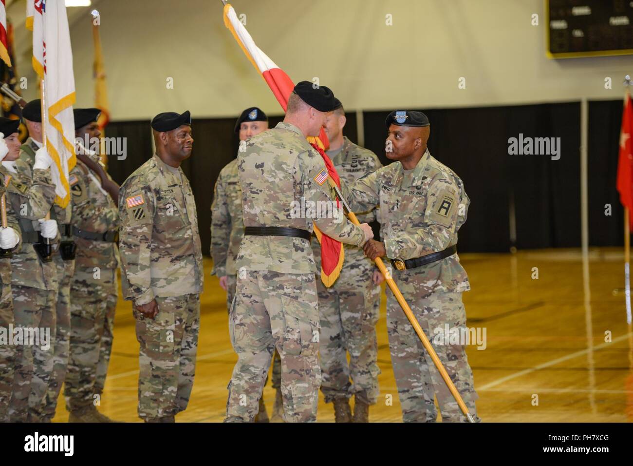 LTG Stephen Twitty passes the battalion flag to incoming Command General MR Terrance McKenrick during the First Army East Change of Command and Change of Responsibility Ceremony at Fort Knox, Kentucky. Stock Photo