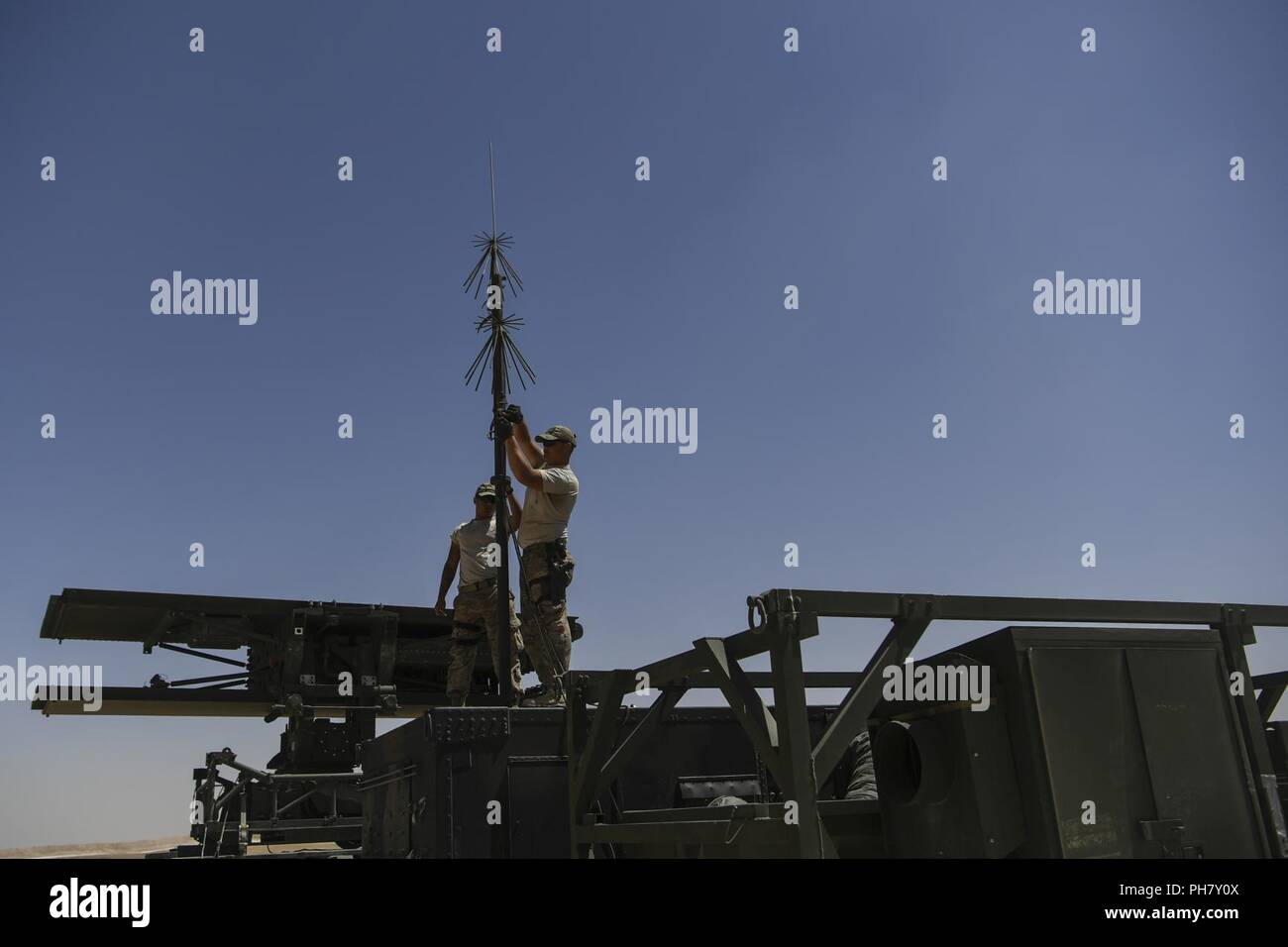 U.S. Air Force Airmen assigned to the 727th Expeditionary Air Control Squadron (EASC) work on setting up a radar at a Coalition airfield in Northeast Syria, June 29, 2018. Comprised of 14 career fields,the 727th EACS is setting up the site to support their radars that provide a constant live picture of the airspace for Operation Inherent Resolve in Iraq and Syria, and the NATO Resolute Support Mission and Operation Freedom's Sentinel in Afghanistan. Stock Photo