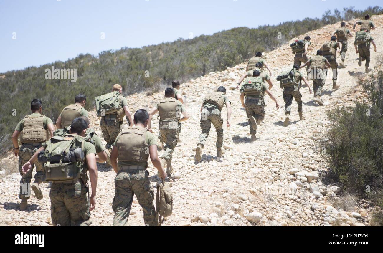Marines with Marine Wing Communications Squadron (MWCS) 48 sprint uphill during a field training exercise at Marine Corps Air Station Miramar, Calif., June 18. From June 14 to 18, MWCS-48 Marines conducted a field exercise using organic, terrestrial and satellite communications capabilities to maintain contact with an aviation combat element, teaching and sustaining their proficiency in setting up and maintaining communication equipment. Stock Photo