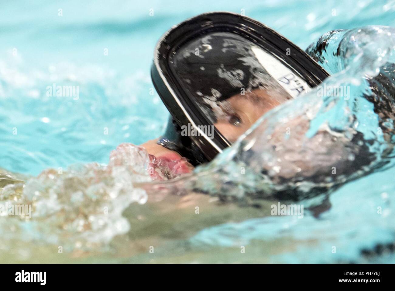 Air Force Tech Sgt. Jerimiah Baumgartner swims during a workout at the pool for the 350th Battlefield Airman Training Squadron preparatory course at Joint Base San Antonio-Lackland in San Antonio, Texas June 27, 2018. Baumgartner experienced many of the same challenges the squadron presents to his recruits. Stock Photo
