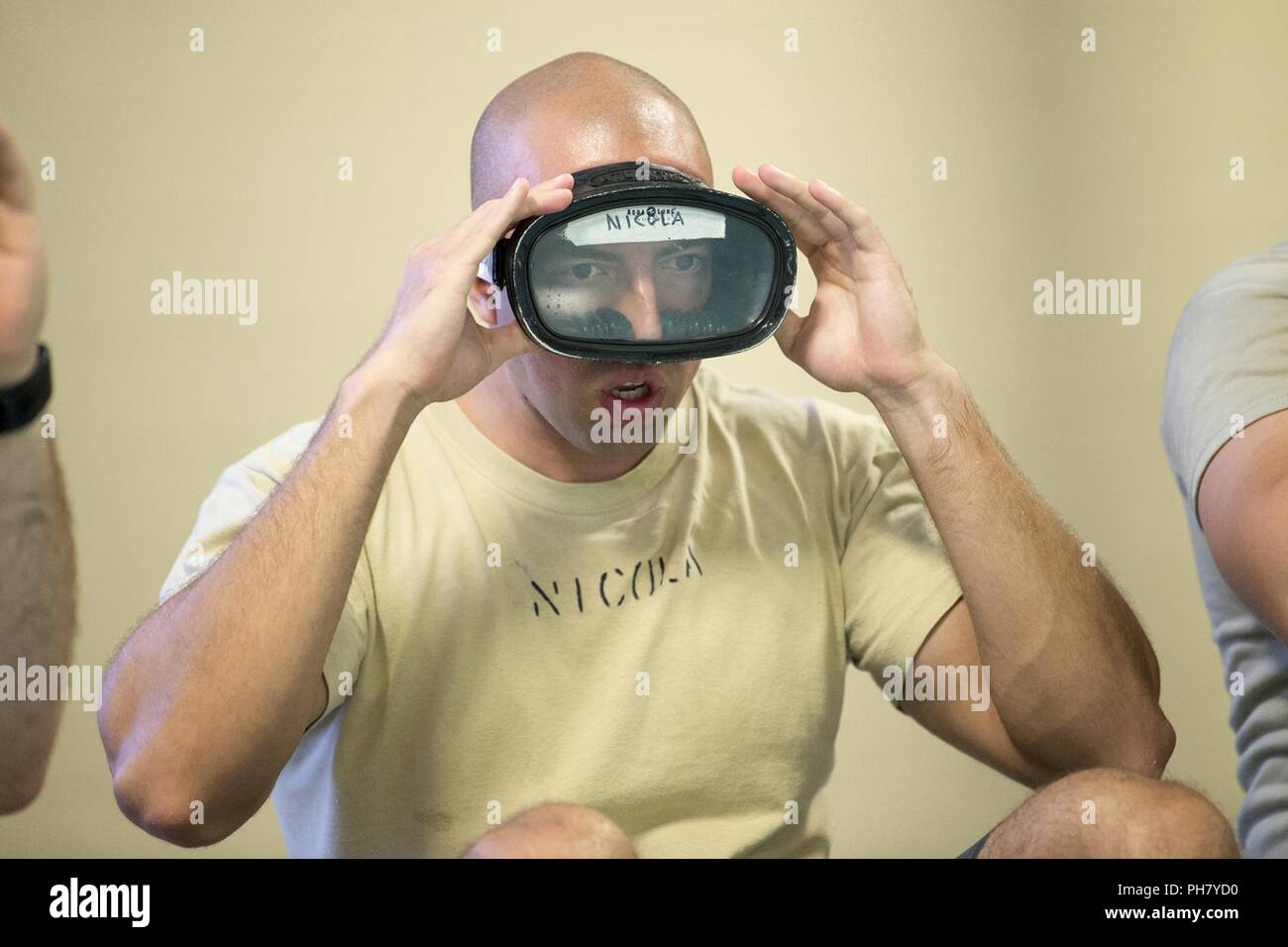 Air Force Special Operations Recruiter Tech Sgt. Adam Nicola adjusts a ...