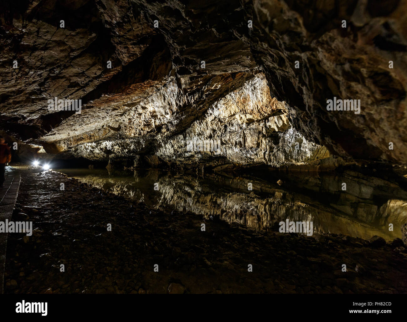 Dripstones reflected in little steam, dripstone cave Stock Photo