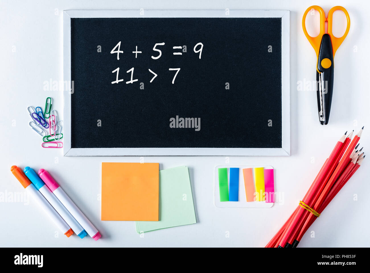 top view of blackboard with math sums and variety school supplies on ...
