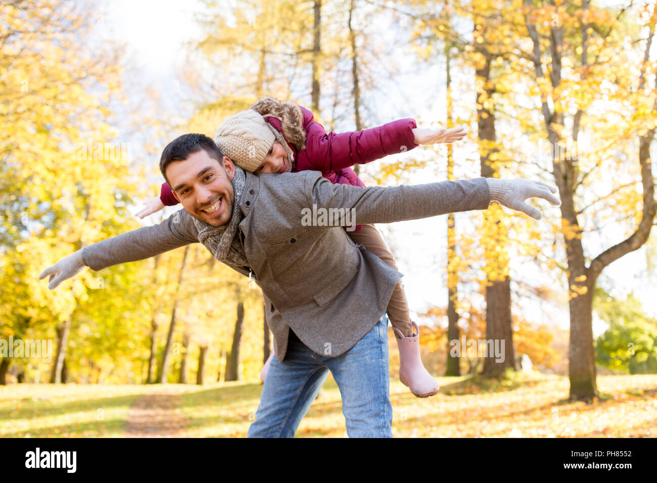 happy father and daughter playing at autumn park Stock Photo - Alamy
