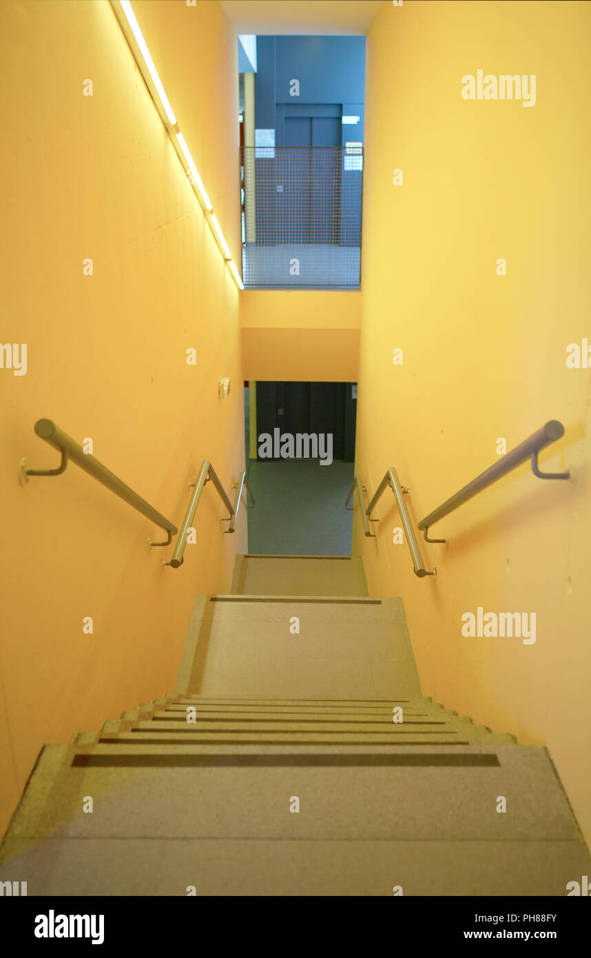 Yellow Walls Building Interior With Stairs And Handrails