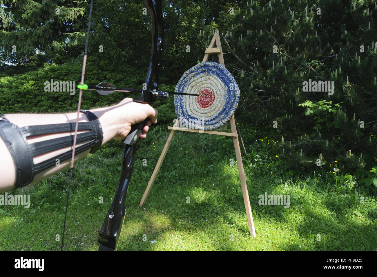 With arrow ond bow shooting of a target. Stock Photo