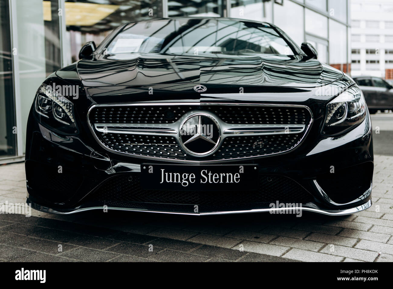 Berlin August 29 2018 A Close Up Of The New Black Mercedes Benz Slc Is Parked Next To The Official Mercedes Benz Dealership In Berlin The Inscription In German Is Translated As Young Stars Stock