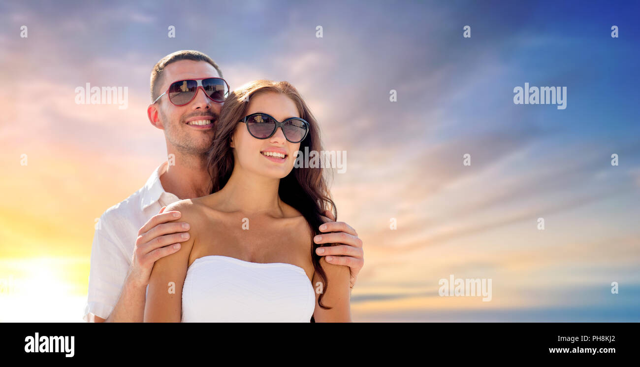 happy couple hugging over sunset sky background Stock Photo - Alamy