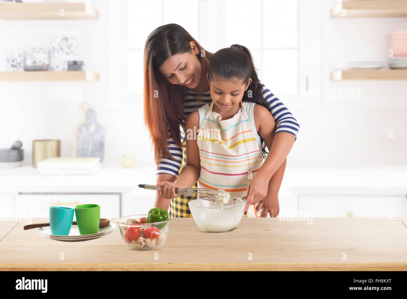 Mother and daughter kneading dough together in kitchen Stock Photo - Alamy