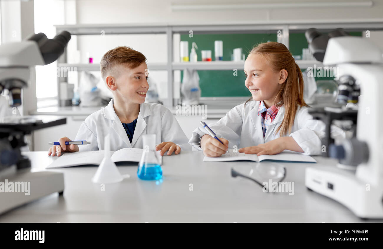 happy kids studying chemistry at school laboratory Stock Photo - Alamy