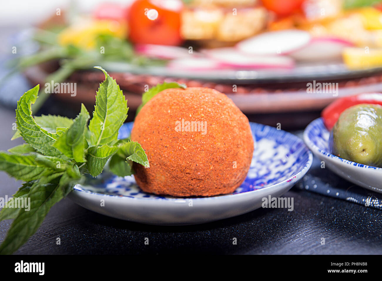 Garnish Bowling Ball Countertop Decoration cheese belper knolle in spices red and black pepper decorated with mint stock image
