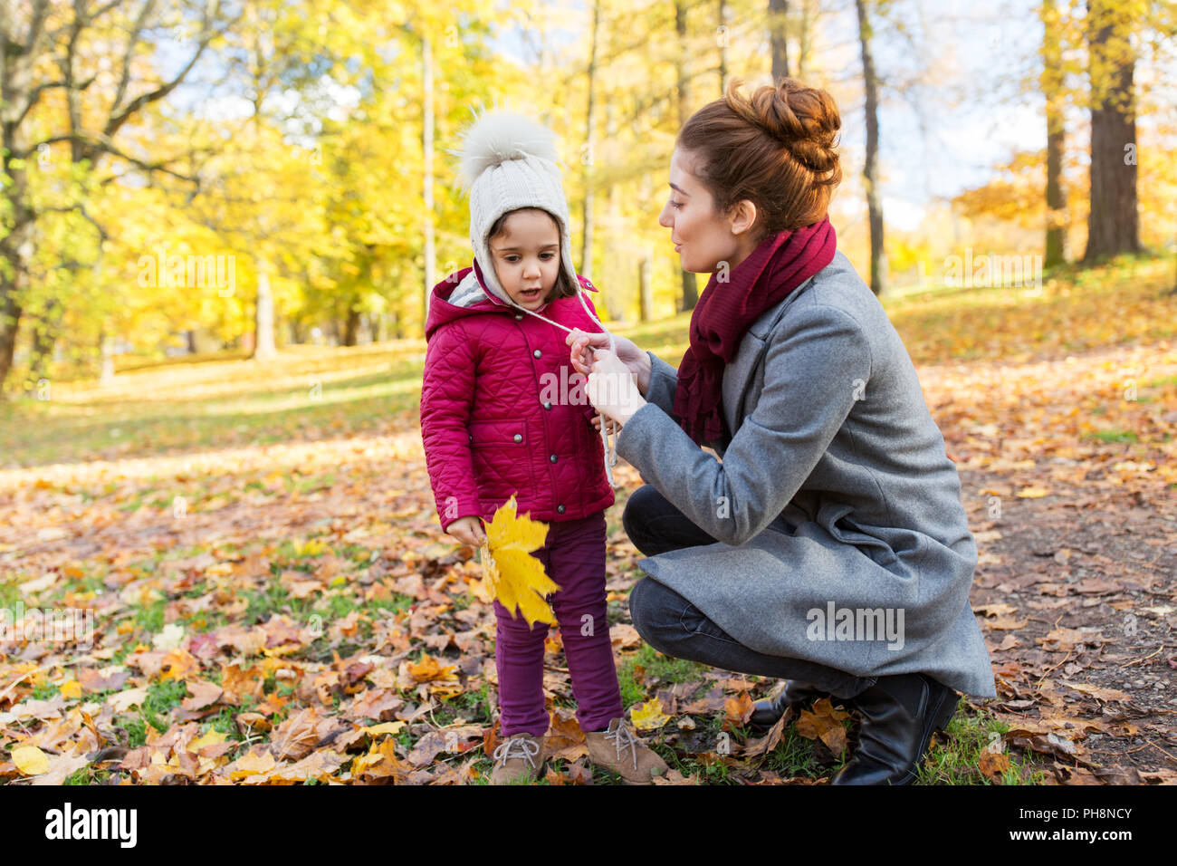 happy family with autumn leaves at park Stock Photo - Alamy