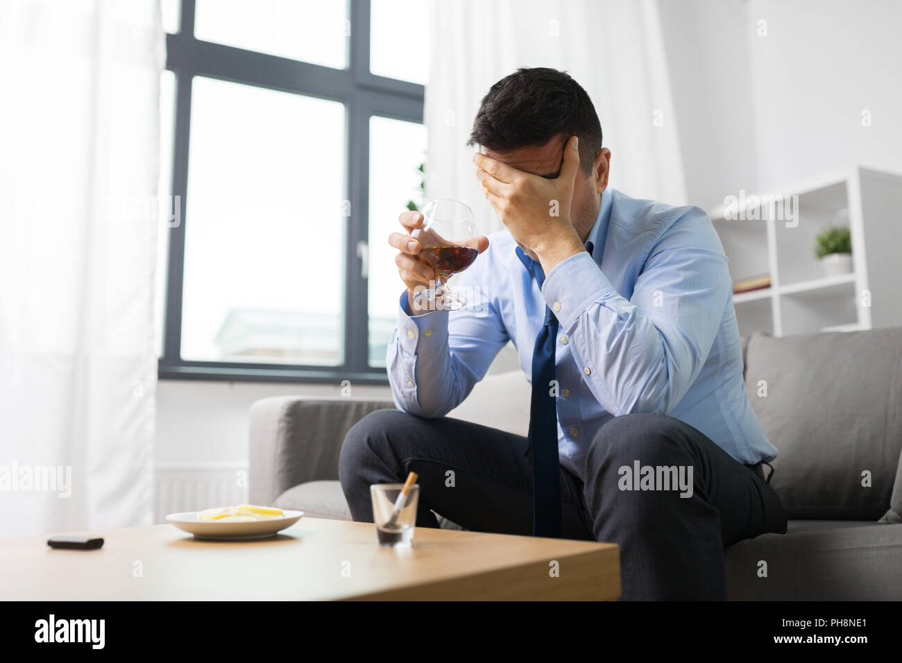 male alcoholic drinking alcohol at home Stock Photo