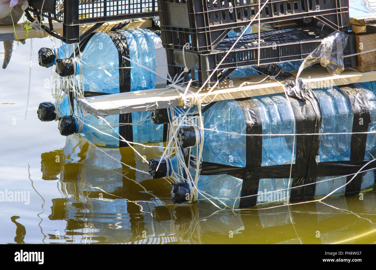 rafts made of recycled plastic bottels to teach reuse Stock Photo - Alamy