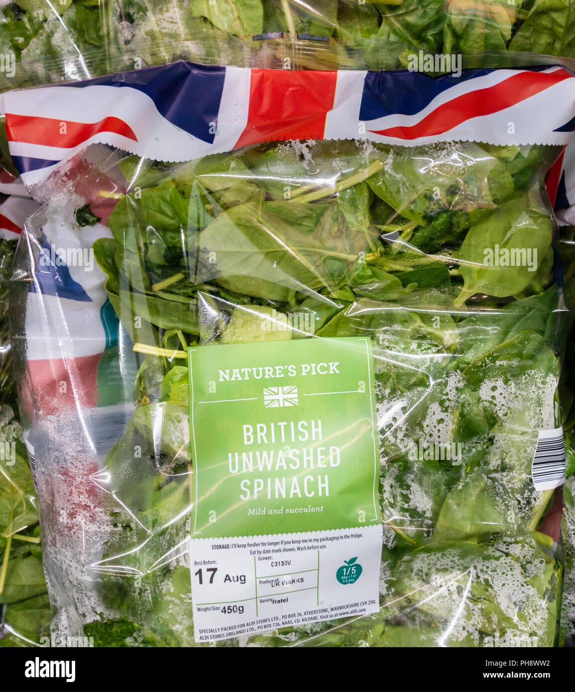 Fresh Spinach in plastic packaging in Aldi supermarket, UK Stock Photo