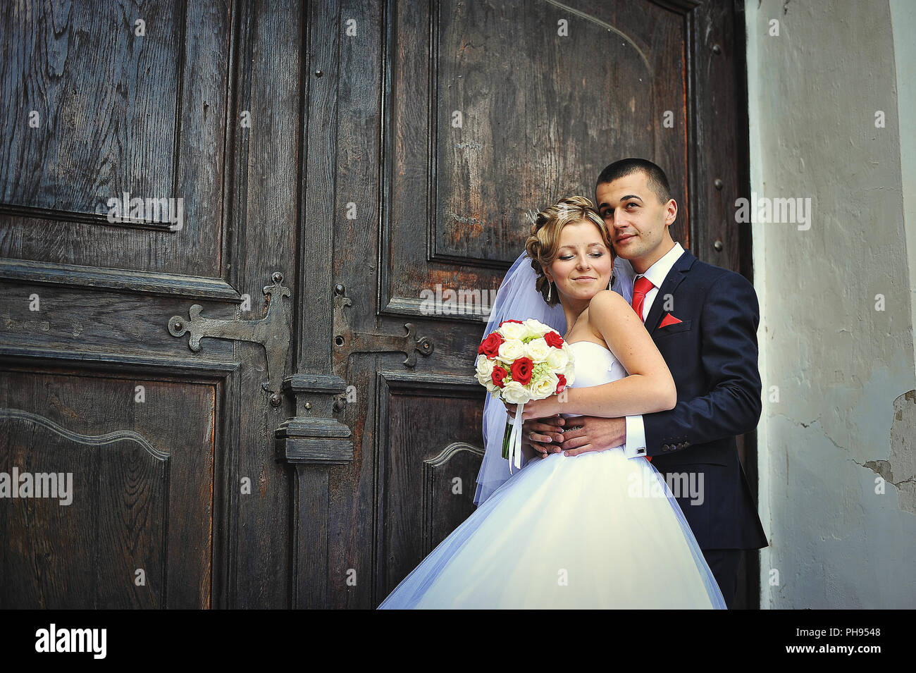 Wedding couple on the background of old wooden door Stock Photo